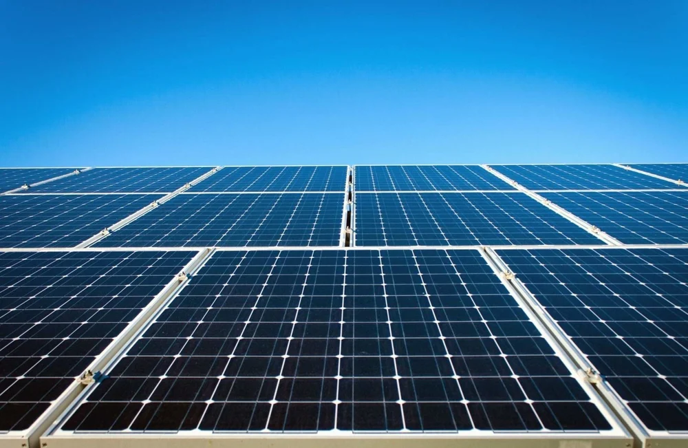 Rows of solar panels under a clear blue sky